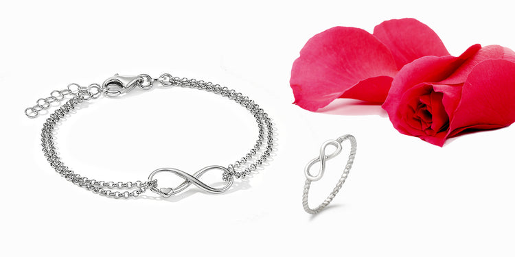 Silbernes Schmuckset mit Unendlichkeitssymbol - Armband und Ring mit Infinity-Motiv, dekoriert mit roten Rosenblüten